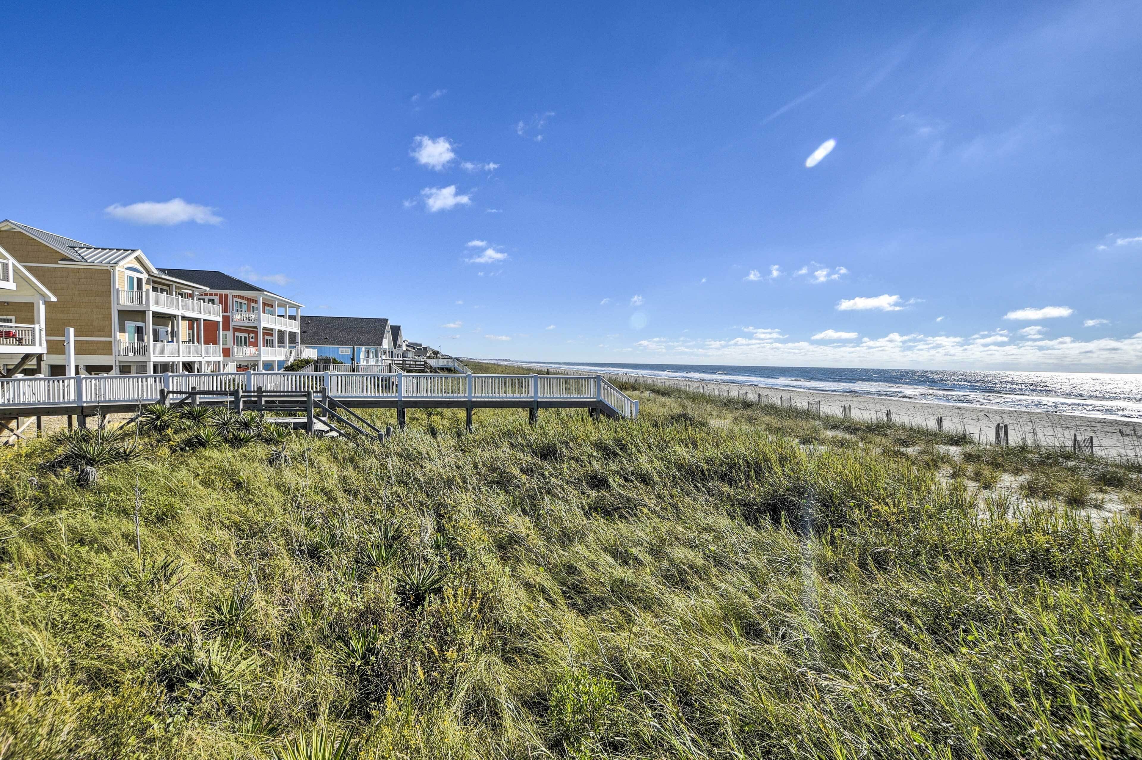 A coastal hotel with a wooden deck and beach access.