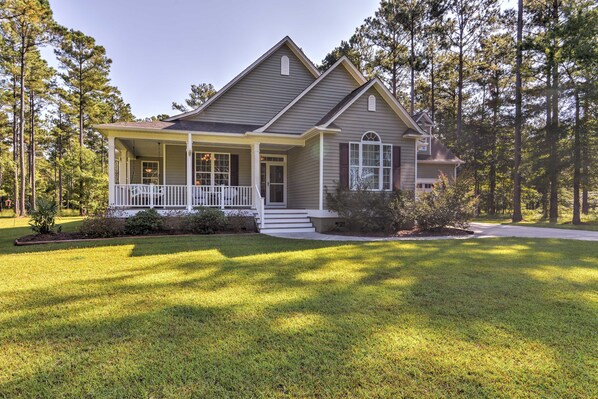 A two-story house with a front porch, a covered entryway, and a well-maintained lawn. - Oriental House on 1 Acre w/ Wraparound Porch! (Arapahoe)