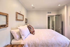 Cozy retreat with a large bed, wooden headboard, and two picture frames.