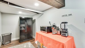 A kitchen with a refrigerator, microwave, coffee maker, and blender on a table. - Waterfront Townville Home: Hot Tub & Lake Access! (Townville)