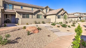 A residential area with multiple houses featuring beige exteriors, stone roofs, and landscaped gardens with gravel pathways and small plants. - St George Area Townhome w/ Patio + Pool Access (Washington)