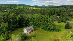 A large house surrounded by dense forest and hills. - Peaceful & Private Franconia Home by Cannon! (Franconia)