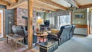 A cozy living room with a fireplace, leather sofas, and a television. - Cozy Conway Area Home ~ 4 Mi to Cranmore Mountain! (Intervale)