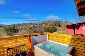 A hot tub on a balcony with a view of houses and trees. - Studio w/ Loft, Hot Tub & Views in Marshall! (Marshall)