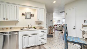 A modern kitchen with white cabinetry, stainless steel appliances, and a central island. - Mountain-view Albuquerque Townhome w/ Patio! (Albuquerque)