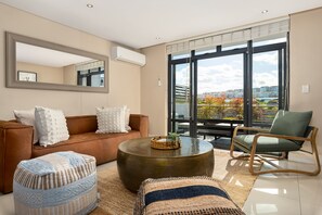 Exclusive Apartment | Living area | 50-inch flat-screen TV with cable channels, TV, Netflix - Eden on The Bay 134 (Cape Town)