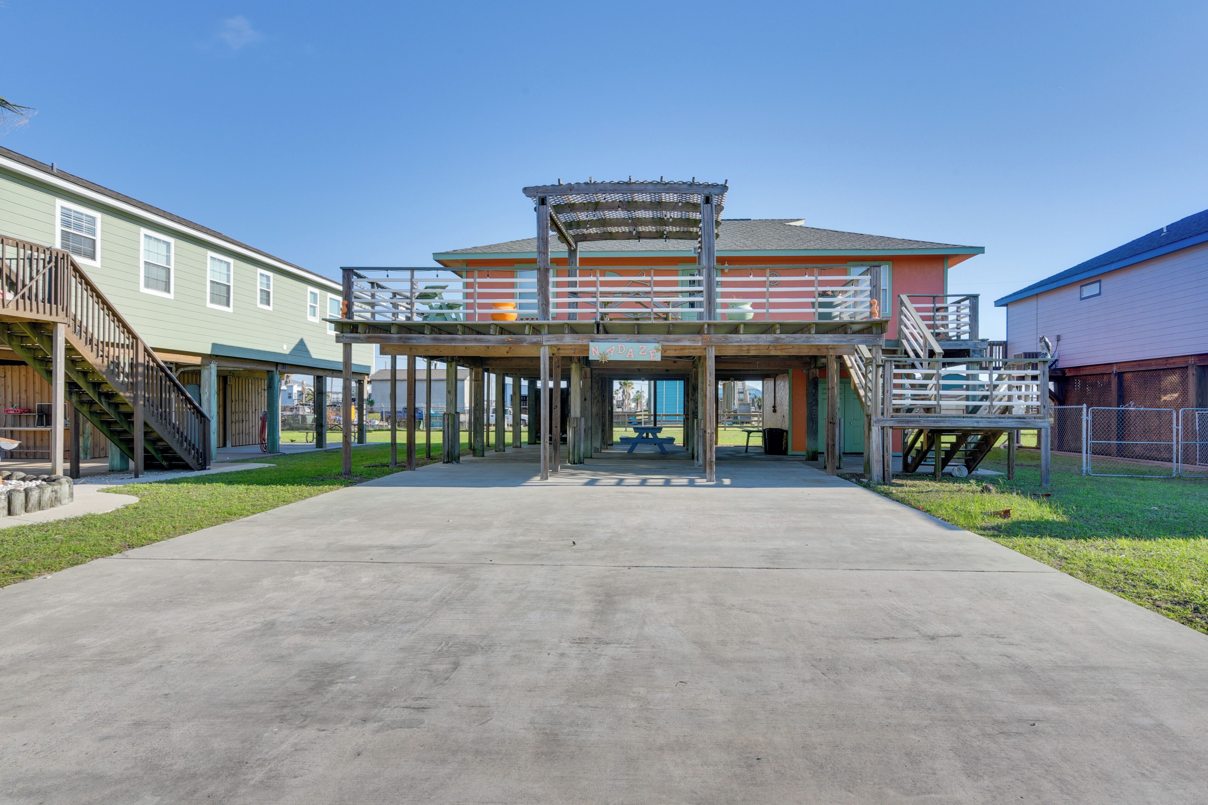 A building with a covered entrance and a picnic table in front.