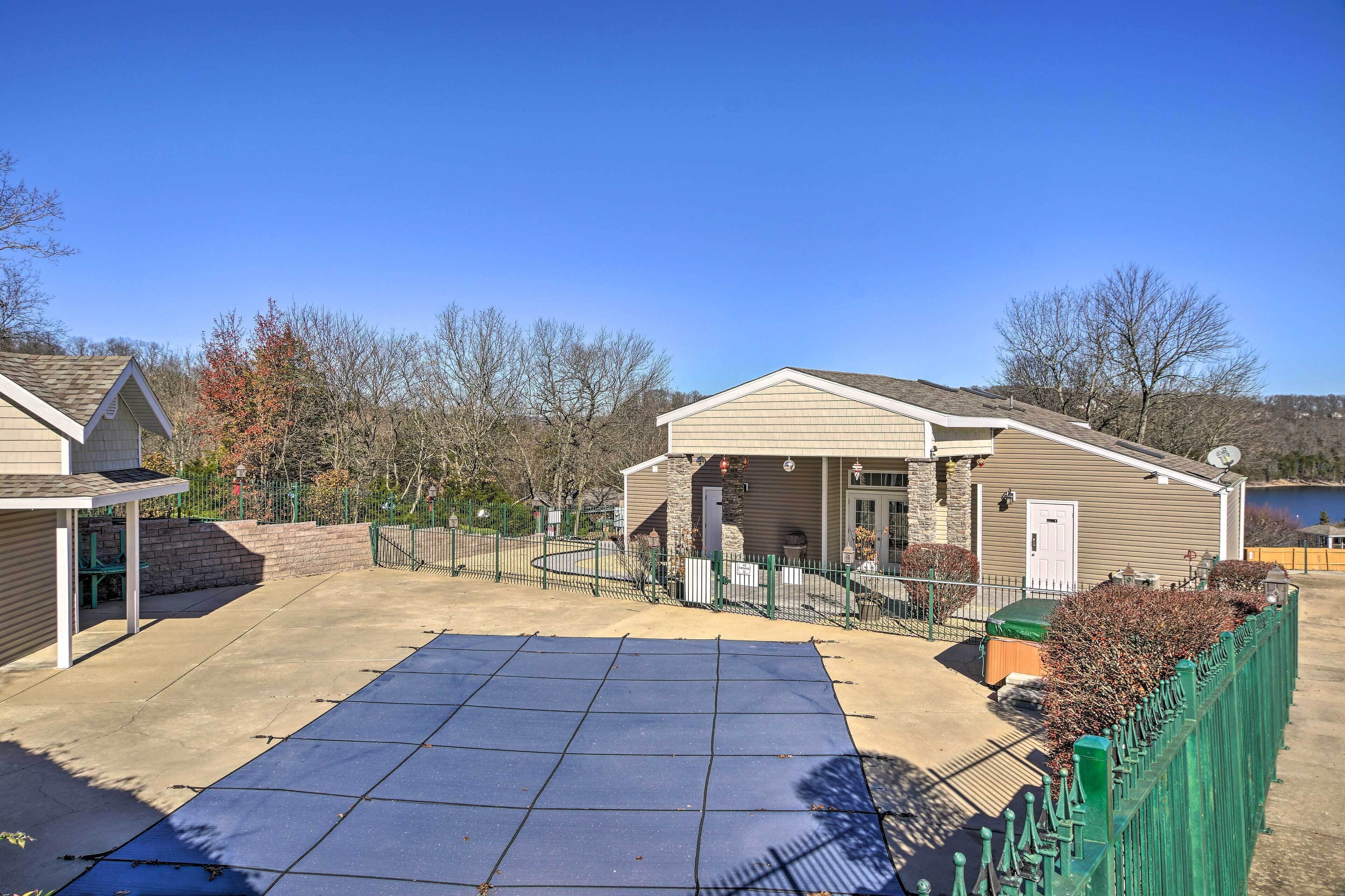 A residential property with a covered patio, a fenced yard, and a solar panel array.