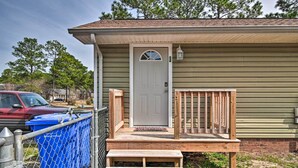 A single-story house with a front porch, a door with a small window, and a mailbox. - Pet-friendly Fayetteville Vacation Rental! (Fayetteville)