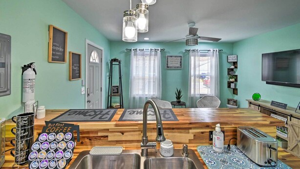 A kitchen with a wooden countertop, stainless steel sink, and a coffee station. - Pet-friendly Fayetteville Vacation Rental! (Fayetteville)