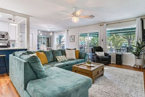 A modern living room with a sectional sofa, a coffee table, and a ceiling fan. - Bring Your Boat! 'granbury on the Lake' w/ Deck (Granbury)