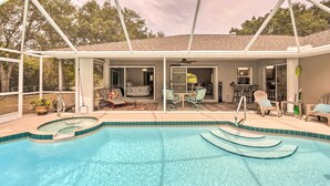 A covered outdoor swimming pool with lounge chairs and a patio area. - Englewood Escape w/ Pool ~ 6 Mi to Beaches! (Englewood)