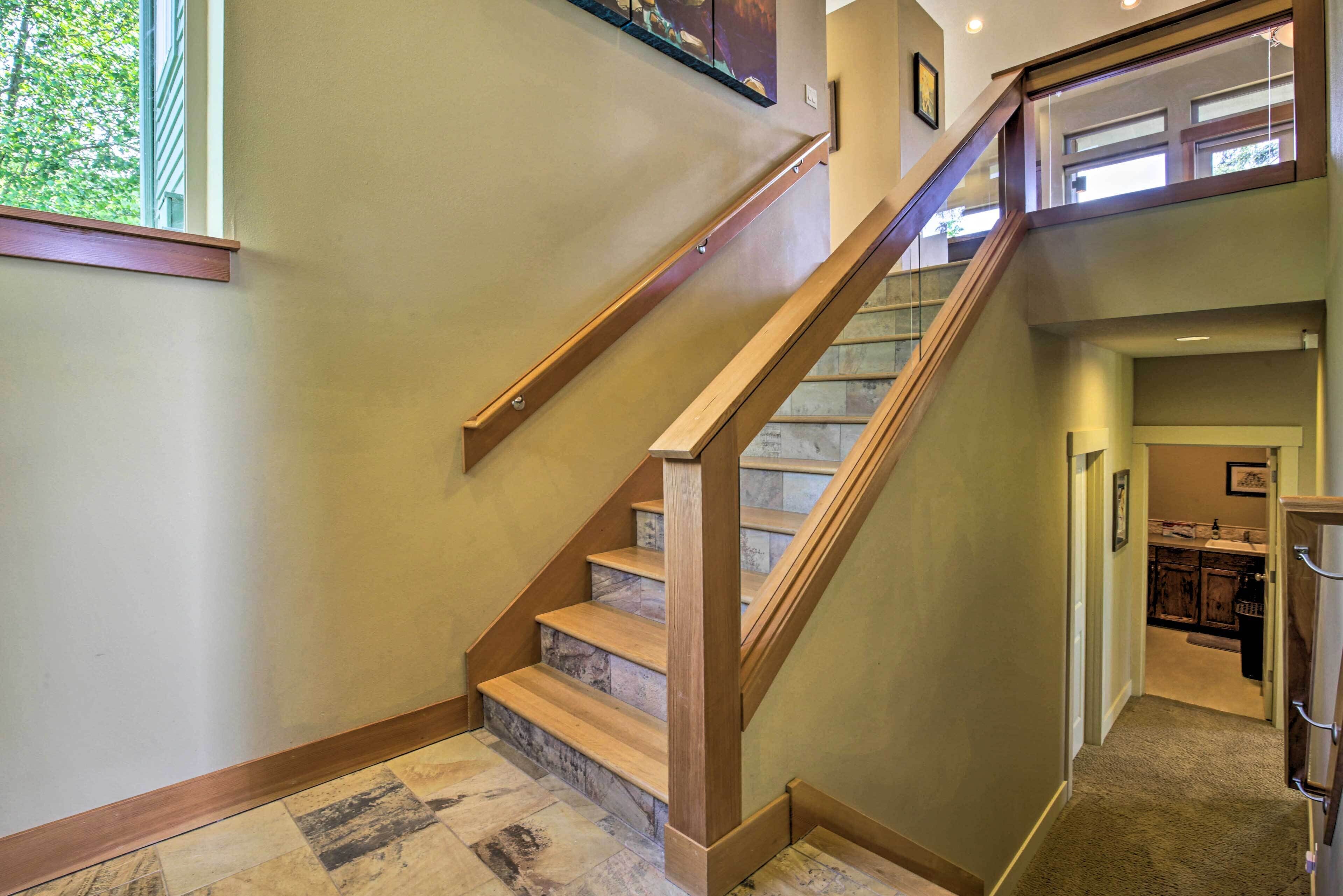 A staircase with wooden steps and a handrail, leading to an upper floor.