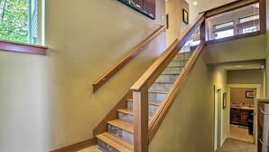 A staircase with wooden steps and a handrail, leading to an upper floor. - Luxe Coastal Haven w/ Bay Views & Hot Tub (Bay City)