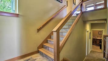 A staircase with wooden steps and a handrail, leading to an upper floor.