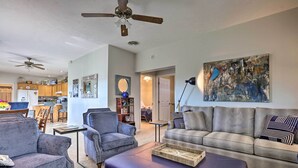 A living room with a sofa, armchairs, a coffee table, and a ceiling fan. - Family Farmhouse on 160-acre Ranch w/ Hiking Trail (Lawrenceburg)