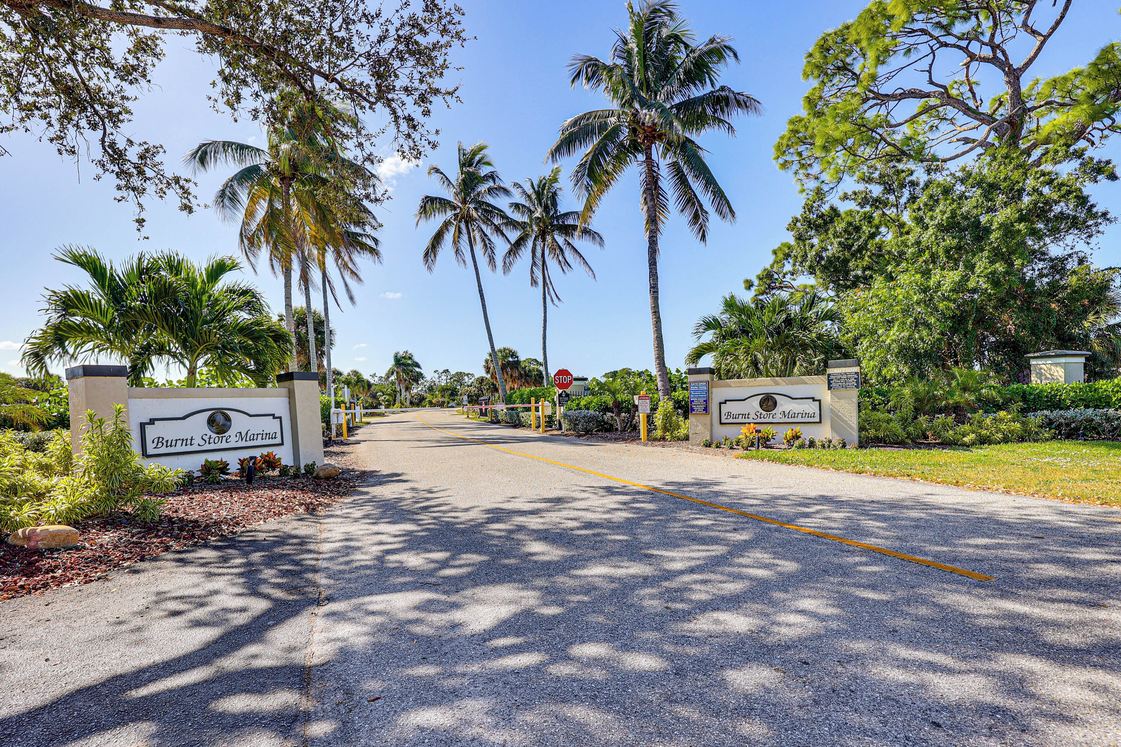 A road leading to a property with a sign reading "Burnt Store Marina".