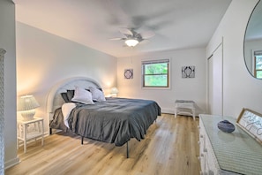 A bedroom with a bed, a ceiling fan, a window, and a small table with a lamp. - Roomy Montour Falls Retreat w/ Private Pool! (Montour Falls)