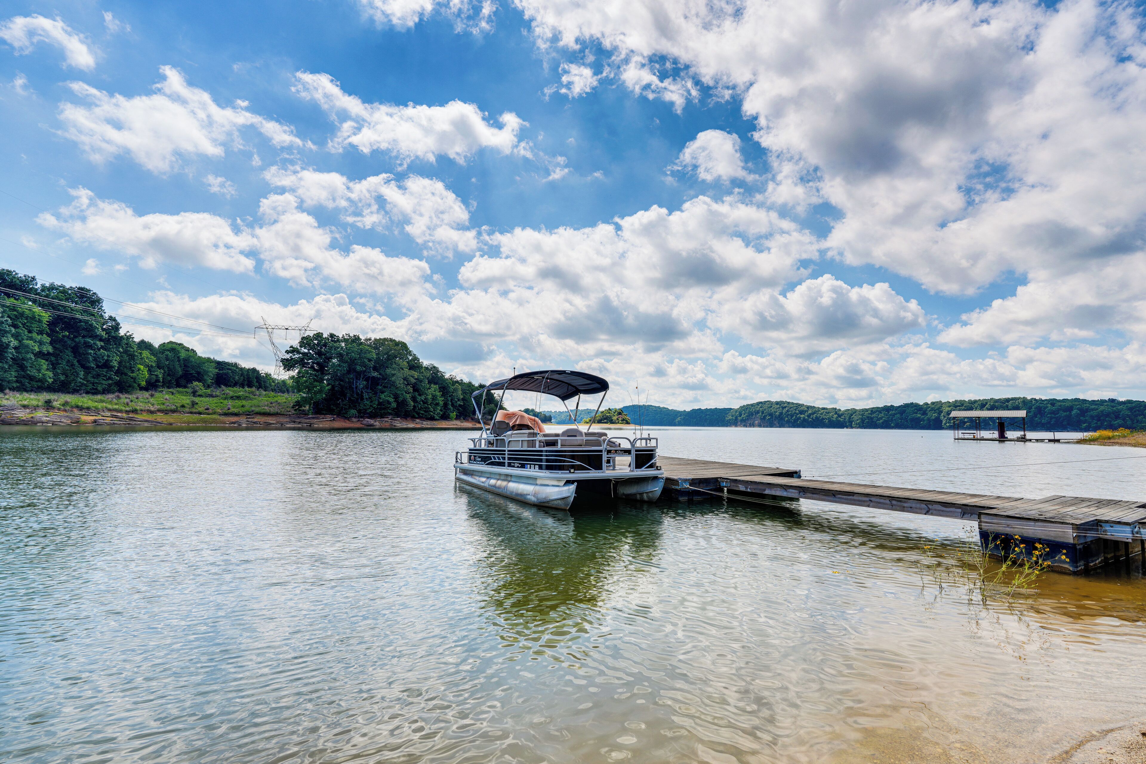 A lake with a dock and a boat.
