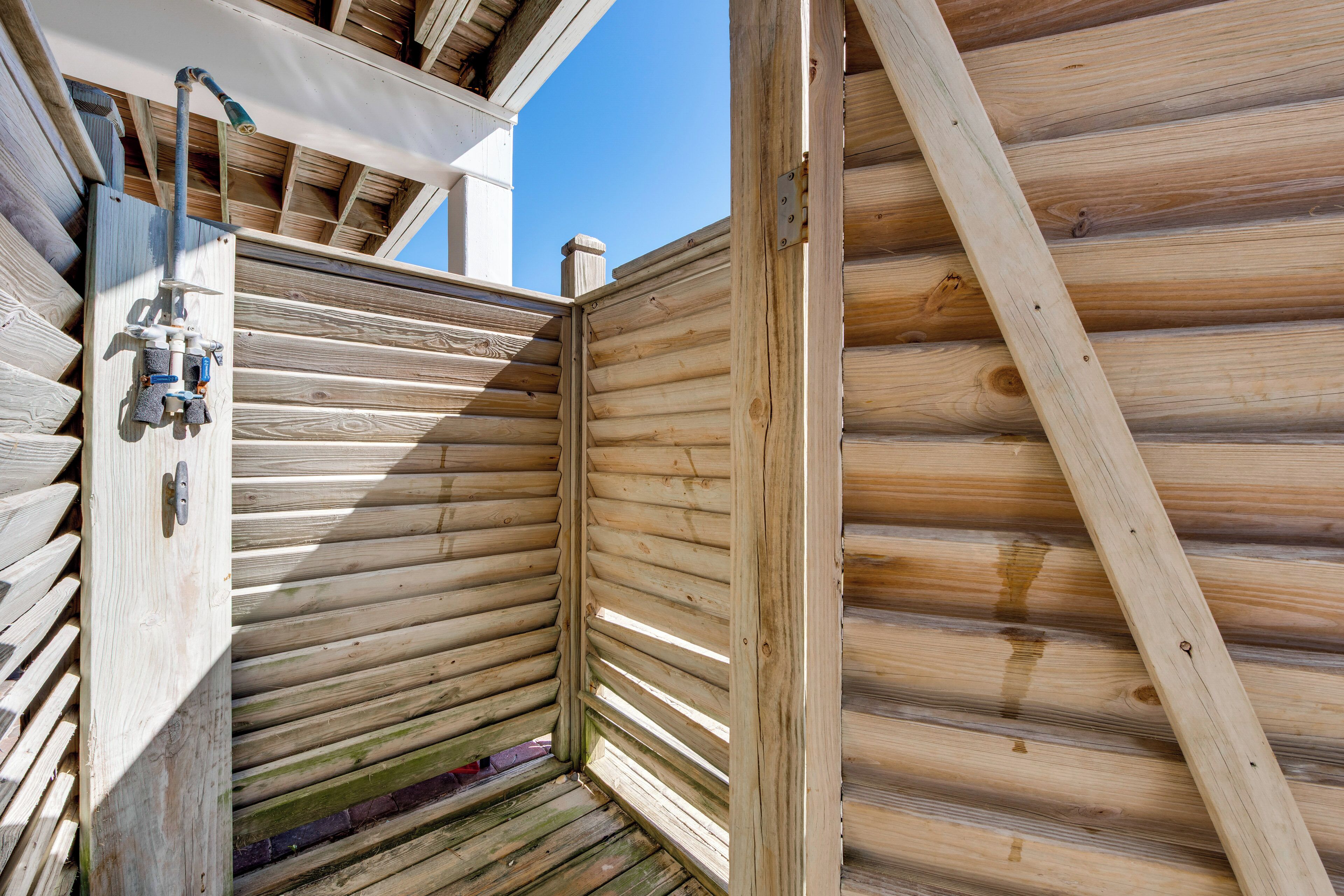 A wooden cabin with a wooden exterior, a window, and a door.
