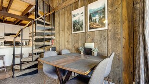 A rustic interior with a wooden staircase, a dining table with chairs, and two framed landscape paintings on the wall. - Townhome w/ Mtn View - Walk to Brian Head Lifts! (Brian Head)