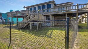 A two-story building with a wooden deck and a covered walkway.
