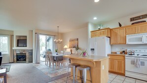 A spacious kitchen with wooden cabinets, a central island, and a built-in microwave. - Charming Redmond Townhome w/ Resort Amenities (Redmond)