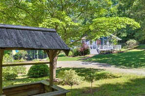 A wooden gazebo with a bench, surrounded by a well-maintained lawn and trees. - Hot Tub, Fire Pit: Family-friendly Murphy Home (Murphy)