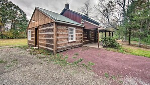 A rustic log cabin with a metal roof and a covered porch. - Remote 1901 Studio Cabin w/ Loft - Pets Allowed! (Allenwood)