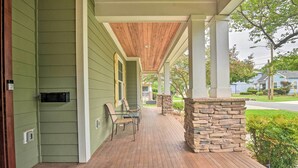 A covered porch with a wooden ceiling, stone pillar, and a brick floor. - 2 Mi to Dtwn: Home in Noda District Near Unc! (Charlotte)