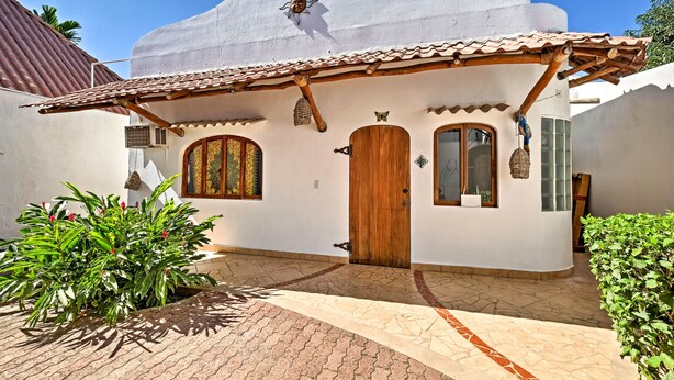 A traditional house with a white facade, a wooden door, and a tiled roof. - Tropical Sayulita Condo w/ Patio & Beach Access! (Sayulita)
