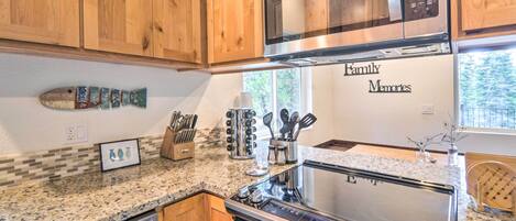 A kitchen with wooden cabinets, a stainless steel microwave, a stove, and a dishwasher.