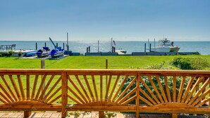 A wooden deck with a view of the sea and boats. - Anchor Bay Getaway on Lake St Clair With Dock! (New Baltimore)
