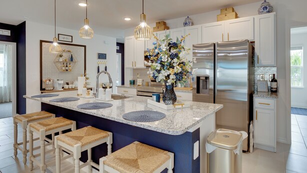 A modern kitchen with a central island, stainless steel appliances, and pendant lighting. - Beautiful Port St Lucie Home w/ Hot Tub! (Port Saint Lucie)