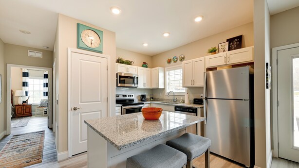 A modern kitchen with white cabinets, stainless steel appliances, a granite countertop, and a built-in oven. - Brownsville Vacation Rental Near National Park! (Brownsville)