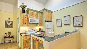 A kitchen with wooden cabinets, a microwave, a refrigerator, and a countertop with a vase of flowers. - 2 Bedrooms, Near Biking Trail, and Frankfort! (Frankfort)