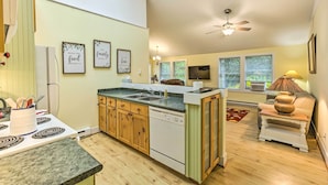 A kitchen with wooden cabinets, a dishwasher, and a stove. There are framed quotes on the wall, a ceiling fan, and a window with blinds. - 2 Bedrooms, Near Biking Trail, and Frankfort! (Frankfort)