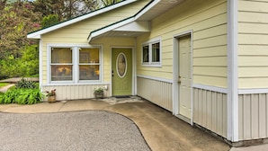 A single-story house with a green door, two windows, and a small porch area with potted plants. - 2 Bedrooms, Near Biking Trail, and Frankfort! (Frankfort)