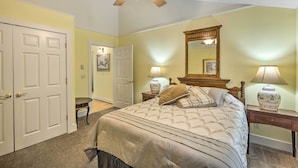 A bedroom with a bed, two bedside tables with lamps, a ceiling fan, a door, and a mirror. - 2 Bedrooms, Near Biking Trail, and Frankfort! (Frankfort)