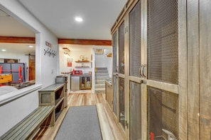 A hallway with a wooden bench, a microwave, and a staircase leading to a room with a view. - Angel Fire Retreat w/ Hot Tub ~ Hike In/out Skiing (Angel Fire)