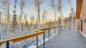 A wooden deck with a metal railing overlooking a snowy forest. - Spacious Mtn Manor, 1 Mi to Brian Head Resort! (Brian Head)