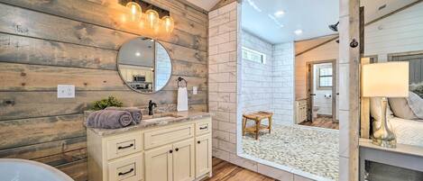 A bathroom with wooden walls, a marble sink, and a large mirror.
