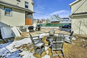 A backyard with outdoor seating, a grill, and a car parked in the driveway. - Elmont Studio Near UBS Arena, 19 Mi to Nyc! (Elmont)
