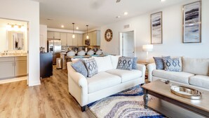 A modern living room with a white sofa, a coffee table, and a ceiling fan. - Bright Lewes Condo w/ Balcony, 7 Mi to Beach! (Lewes)