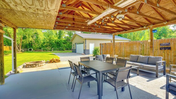 An outdoor patio with a covered seating area, a table, and chairs. - Pet-friendly Clarksville Home w/ Central A/C (Clarksville)