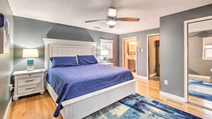 A bedroom with a bed, nightstand, and ceiling fan. - Pet-friendly Clarksville Home w/ Central A/C (Clarksville)