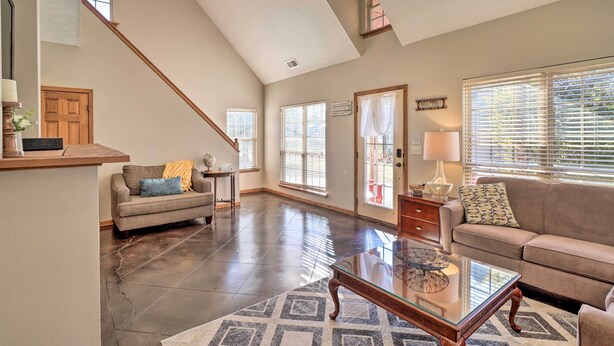 A spacious living room with a high ceiling, a staircase, and large windows. - Heber Springs Cabin ~ 1 Mi to Sugarloaf Mtn! (Heber Springs)