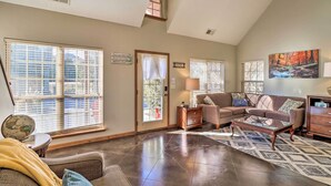 A spacious living room with a high ceiling, large windows, a fireplace, and a cozy seating area. - Heber Springs Cabin ~ 1 Mi to Sugarloaf Mtn! (Heber Springs)