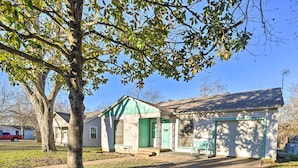 A single-story house with a green front door, a garage, and a small porch area. - Outdoor Dining & Yard: Pet-friendly Temple Home (Temple)