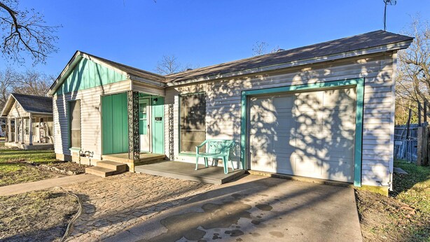 A single-story house with a front porch, a garage, and a small patio area with a bench. - Outdoor Dining & Yard: Pet-friendly Temple Home (Temple)